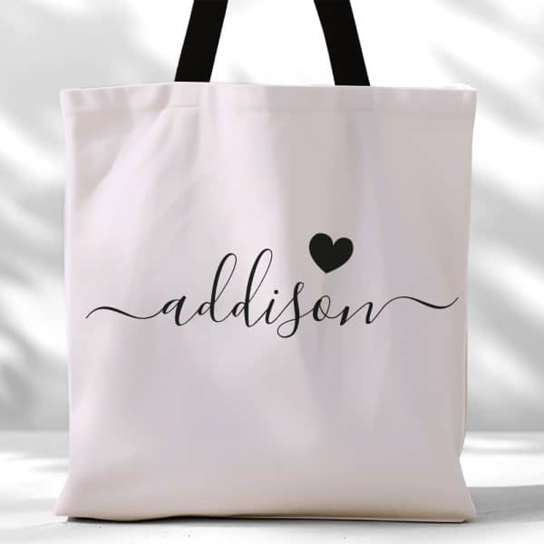 White Tote Bag With Black Handles And The Name Addison In Elegant Script With A Small Heart.