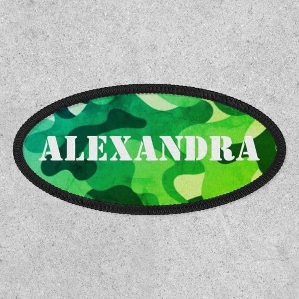 Oval Green Camouflage Patch With The Name Alexandra In White.