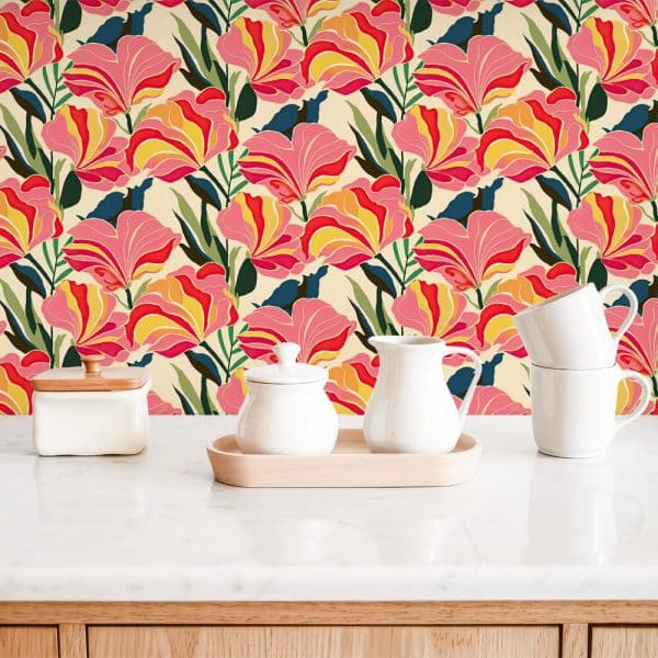 White Kitchenware Sits On A Marble Countertop In Front Of A Floral Wallpaper Featuring Stylized Pink, Red, And Yellow Flowers On A Cream Background.