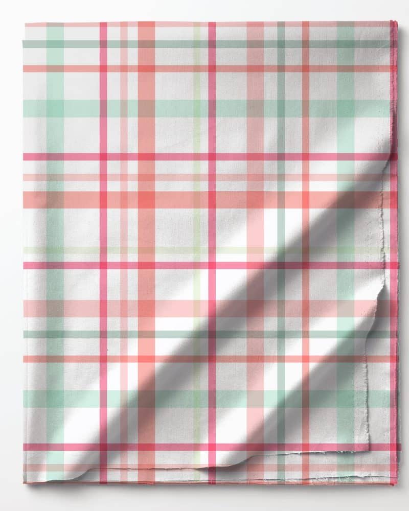 A folded piece of fabric with a pink, green, and white plaid pattern.