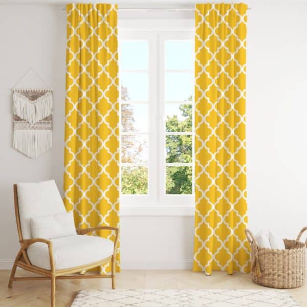 Mustard Yellow Curtains With A White Quatrefoil Pattern Hang In Front Of A Window.