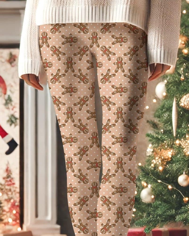 Beige leggings with a repeating pattern of gingerbread men and white polka dots.