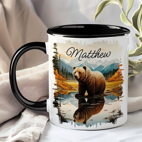Personalized Coffee Mug With A Grizzly Bear Reflected In Calm Water, Mountains In The Background, And The Name Matthew.