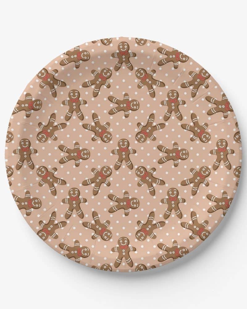 Paper plate with a repeating pattern of gingerbread men on a light brown background with white polka dots.