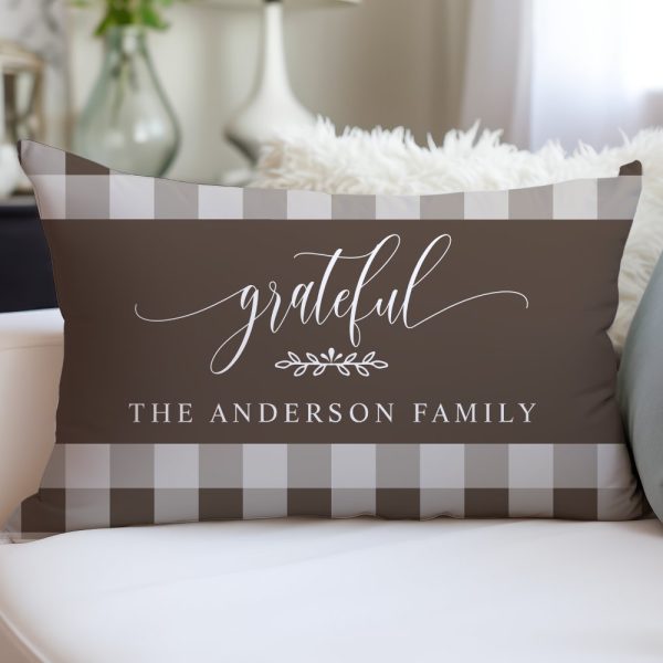Brown And Beige Rectangular Pillow With The Word Grateful In A Script Font, A Small Leaf Design, And The Text The Anderson Family.