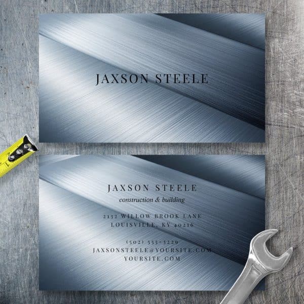 Two Business Cards For Jaxson Steele, Construction And Building, On A Brushed Metal Background.