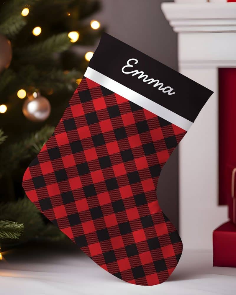 Red and black buffalo plaid Christmas stocking with the name Emma on it.
