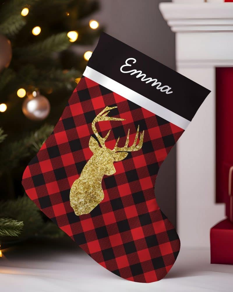 Personalized Christmas stocking with red and black buffalo plaid pattern and gold glitter deer.