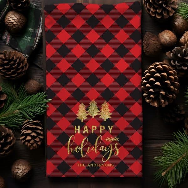 Red And Black Buffalo Plaid Kitchen Towel With Gold Lettering That Says Happy Holidays And The Andersons, And Three Gold Trees.