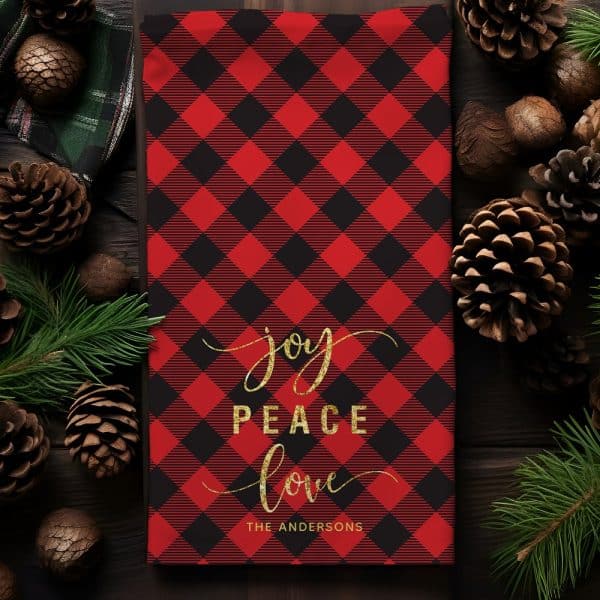 Red And Black Buffalo Plaid Christmas Tea Towel With Gold Lettering Reading Joy Peace Love And The Andersons.