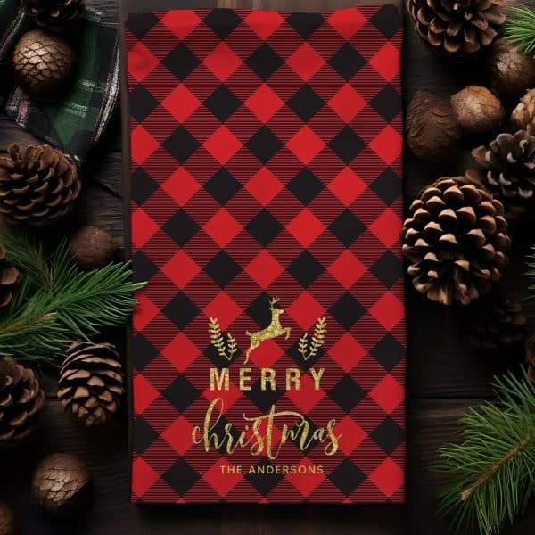 Red And Black Buffalo Plaid Christmas Towel With A Gold Reindeer And Merry Christmas Text.