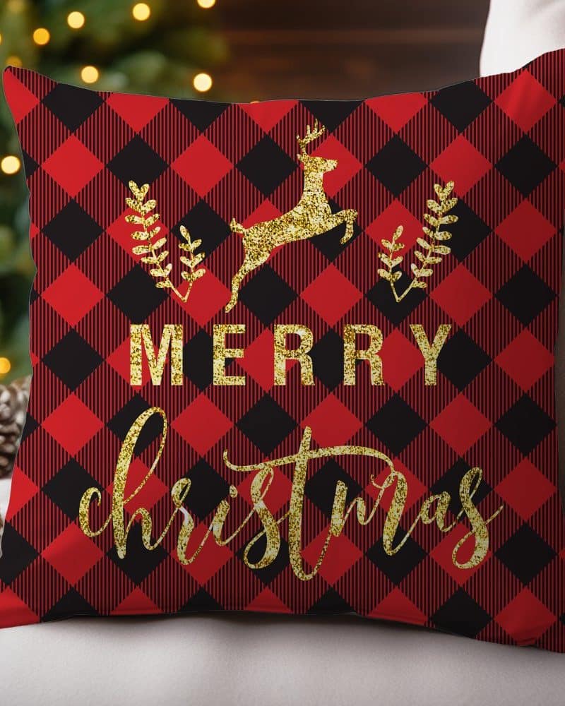 Red and black plaid Christmas pillow with gold glitter lettering that says Merry Christmas and a gold glitter reindeer.