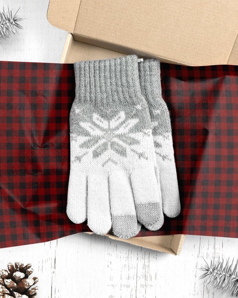 Grey and white snowflake patterned gloves in a gift box.