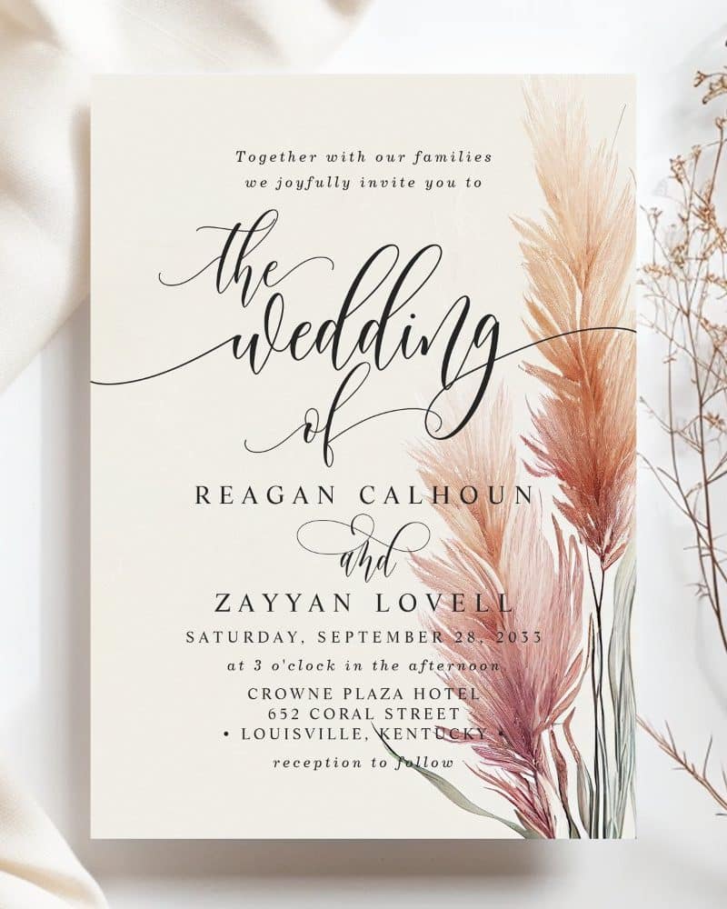Wedding invitation for Reagan Calhoun and Zayyan Lovell, featuring pampas grass illustration.