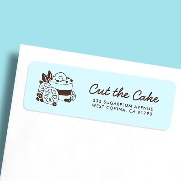 Light Blue Rectangular Return Address Label With A Drawing Of A Cake And Berries, And The Business Name Cut The Cake And Address.
