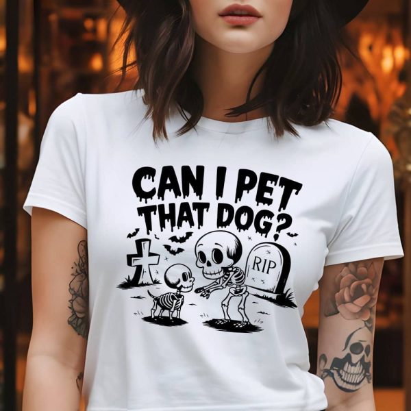 Woman Wearing A White T-Shirt With A Halloween Design Featuring Skeletons Of A Dog And Person, And The Text Can I Pet That Dog?