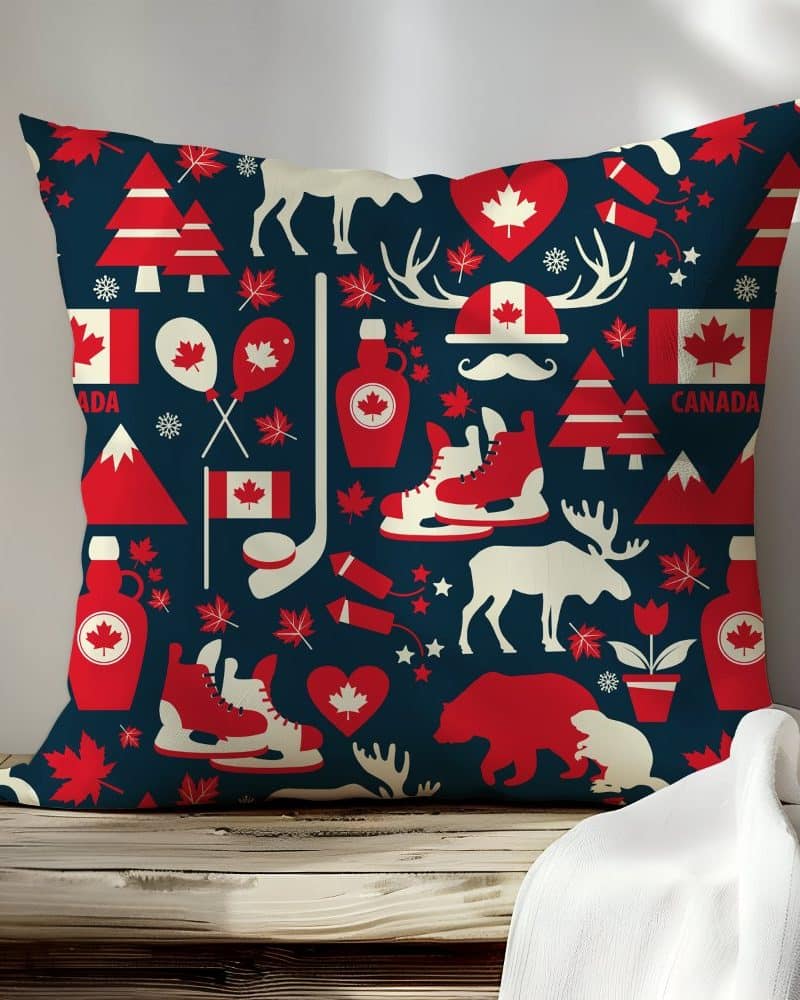 Dark blue square pillow with a repeating pattern of Canadian icons in red and white.