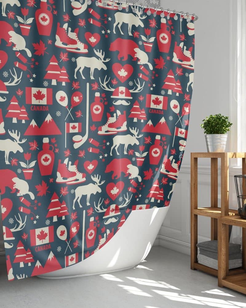 A dark-blue shower curtain with a red and off-white repeating pattern of Canadian icons, including maple leaves, animals, and hockey skates.