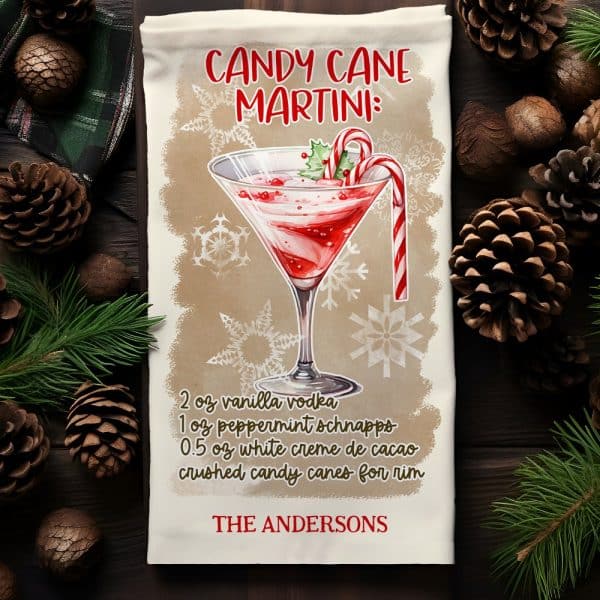 A Kitchen Towel With A Recipe For A Candy Cane Martini, Illustrated With A Watercolor-Style Martini Glass Garnished With A Candy Cane.