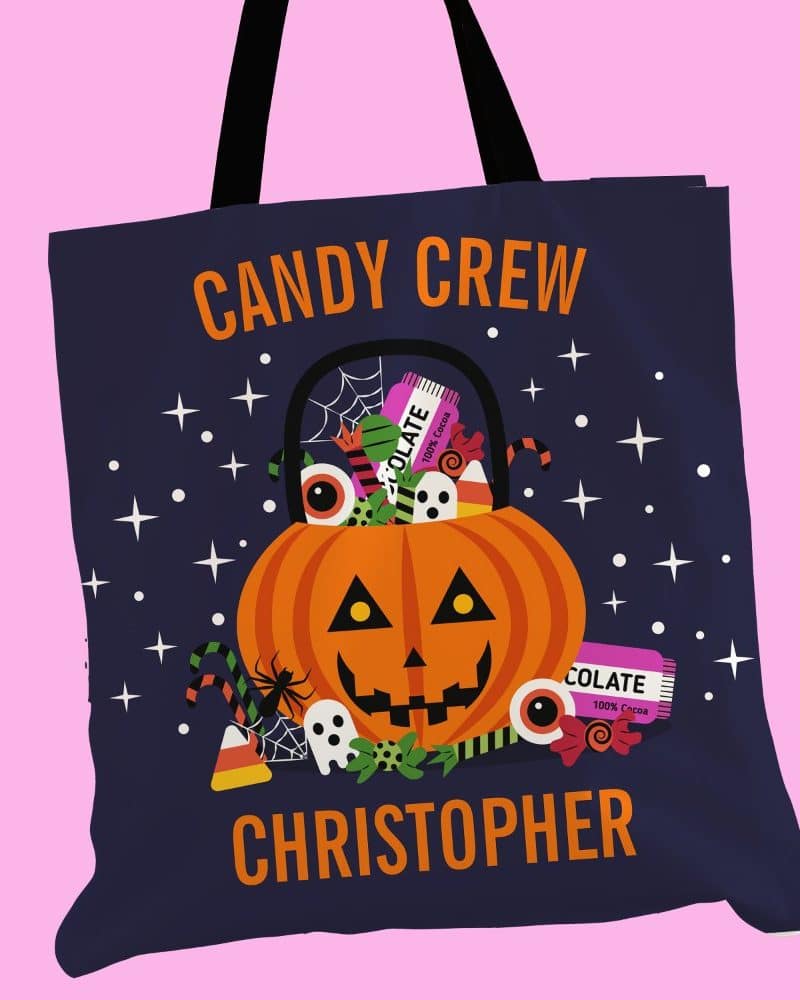 Dark blue Halloween candy tote bag with a jack-o'-lantern design, candy, and the name Christopher.