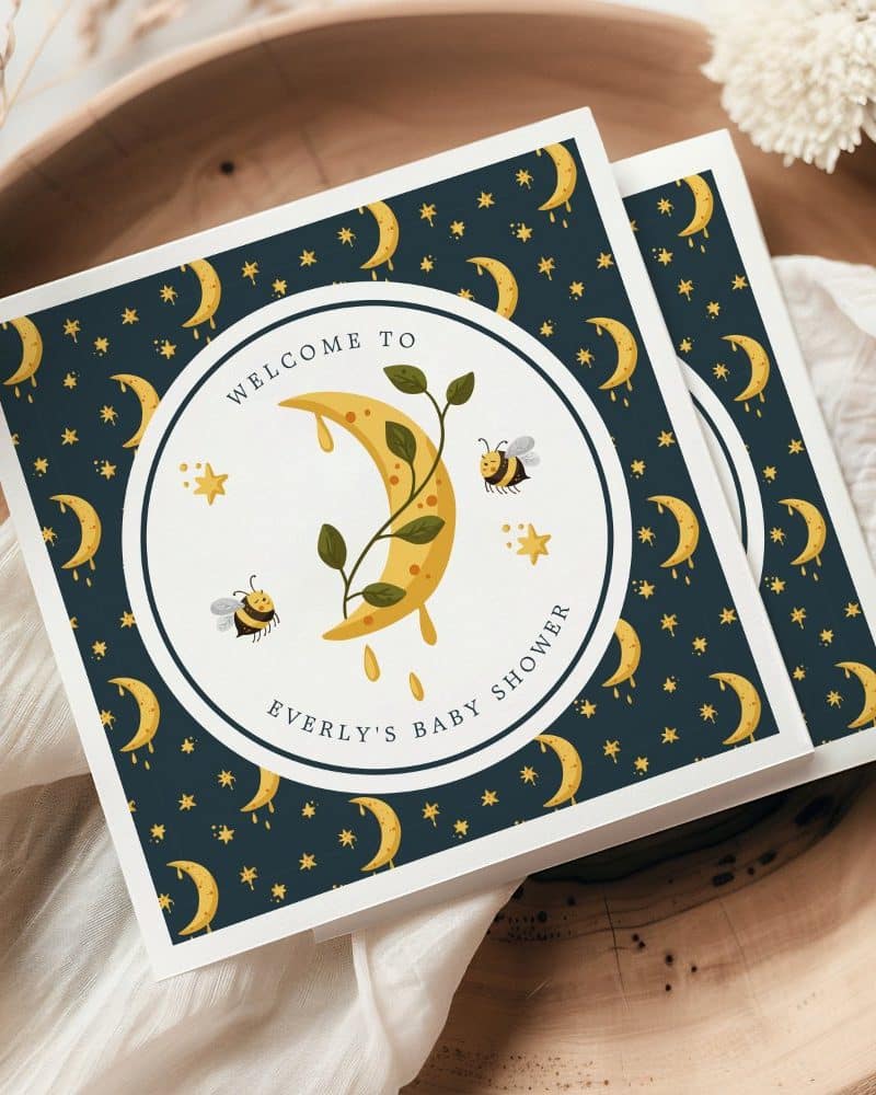 Baby shower invitation featuring a crescent moon with dripping honey, bees, and stars on a dark blue background.