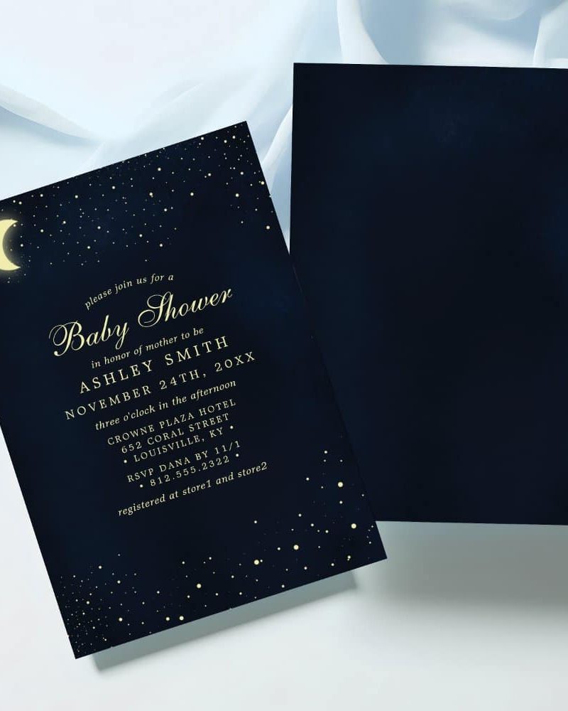 Navy blue baby shower invitation with gold lettering, stars, and a crescent moon.