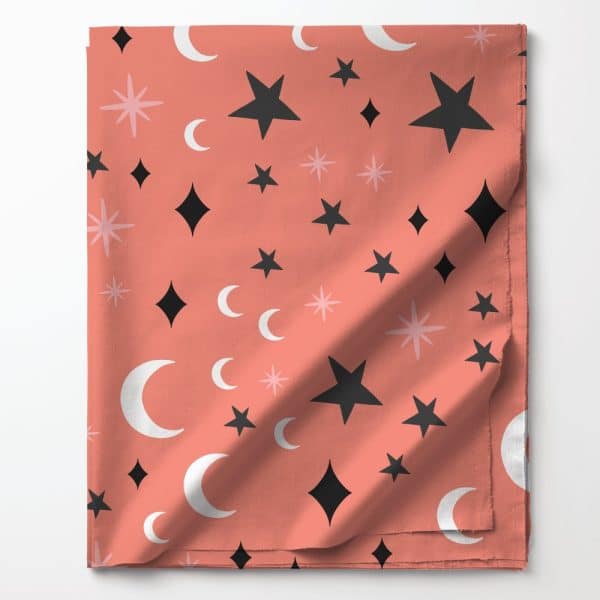 Coral Fabric With A Repeating Pattern Of Black Stars, White Crescent Moons, And Pink Starbursts.