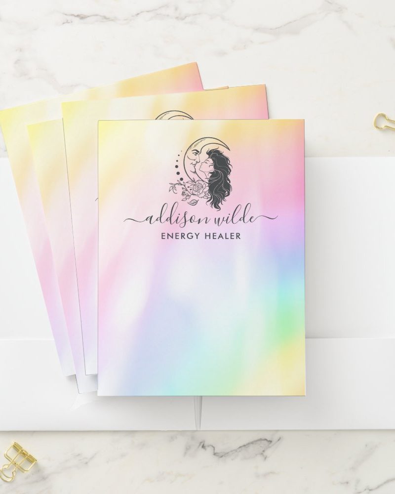 Stack of pastel-colored stationery featuring a logo of a woman's face and hair beside a crescent moon, with the name Addison Wilde, Energy Healer.