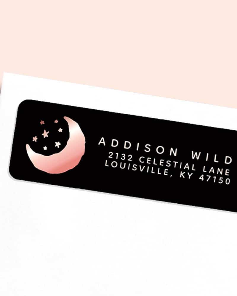 Rose gold crescent moon and stars on a black return address label.