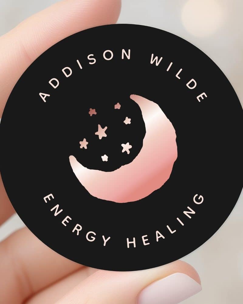 A black circle with rose gold crescent moon and stars, and the text Addison Wilde Energy Healing.