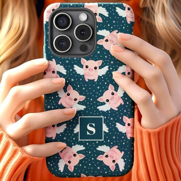 Woman'S Hands Holding A Teal Phone Case Featuring A Repeating Pattern Of Pink Pigs With Wings. The Case Also Includes A Monogram.