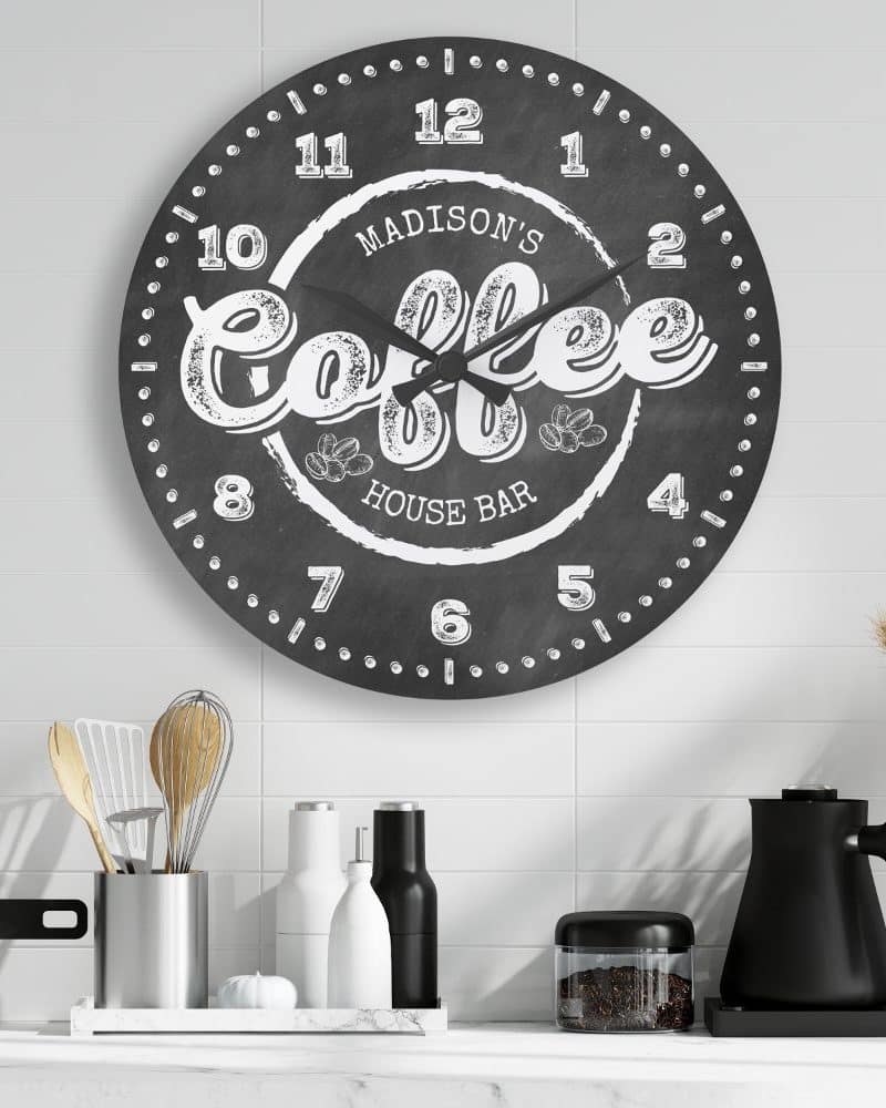 Black round clock with white coffee design.