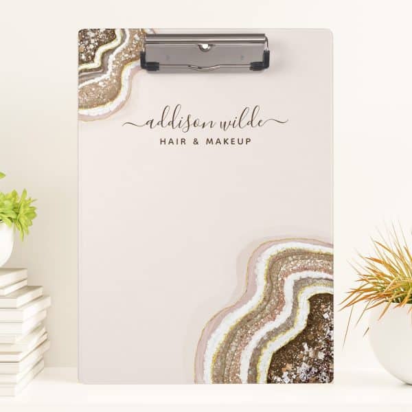 A Clipboard With A Blush Pink Background Features An Agate Design And The Name Addison Wilde Hair &Amp; Makeup.