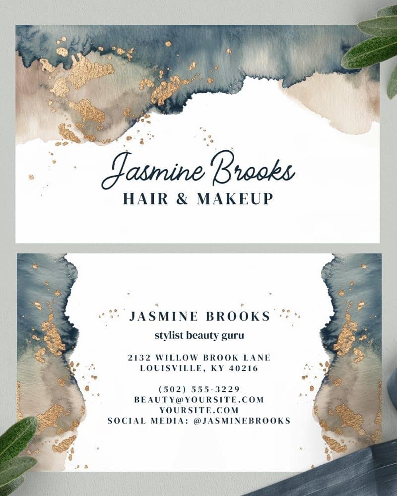 Two business cards featuring a watercolor design in shades of blue and beige with gold accents. The cards display the name Jasmine Brooks, Hair & Makeup.
