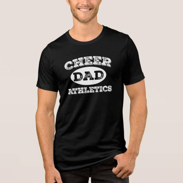 Man Wearing A Black T-Shirt That Says Cheer Dad Athletics In A Distressed White Print.