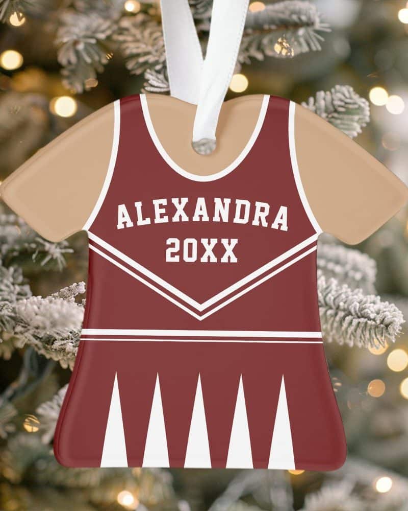 A maroon and tan cheerleader uniform-shaped Christmas ornament with the name Alexandra and the year 20XX.