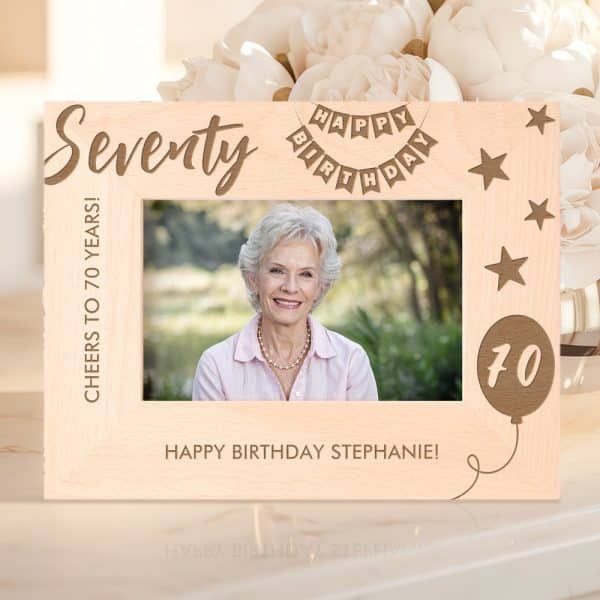 Wooden Photo Frame Celebrating A Woman'S 70Th Birthday. The Frame Is Engraved With &Quot;Seventy,&Quot; &Quot;Happy Birthday,&Quot; And &Quot;Cheers To 70 Years!&Quot; A Photo Of Stephanie Is In The Frame.
