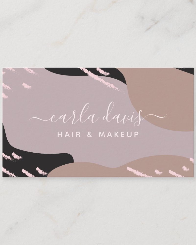 Business card for Carla Davis, Hair & Makeup, featuring an abstract design in shades of pink, brown, and black.
