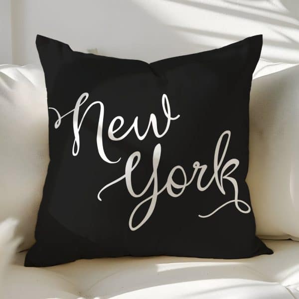 Black Throw Pillow With The Words New York In A White, Stylized Script Font.