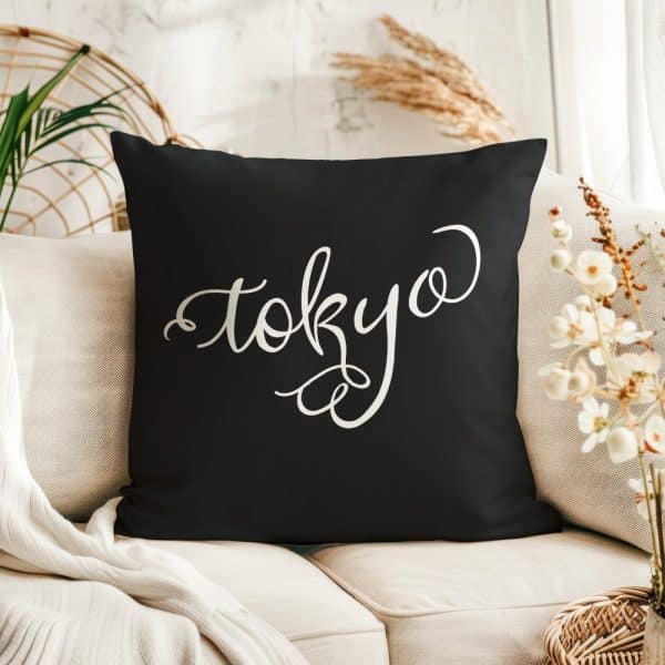 Black Throw Pillow With The Word Tokyo In White Script.