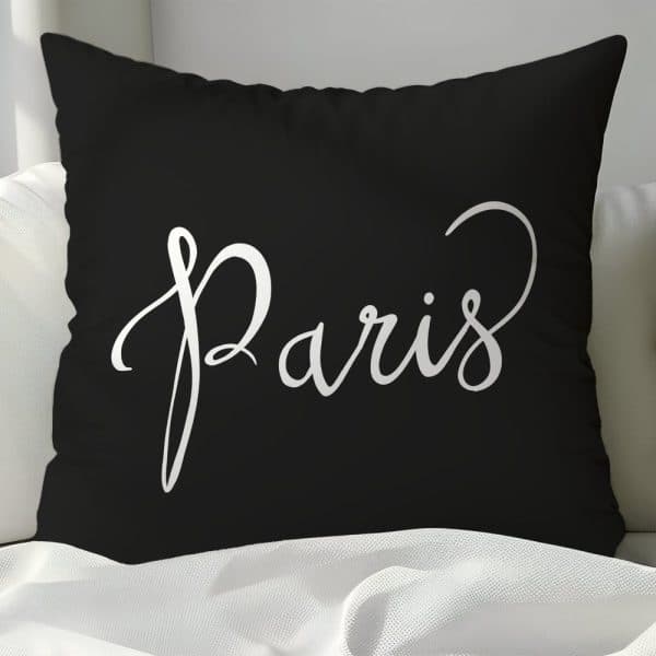 Black Pillow With The Word Paris In A White Script Font.