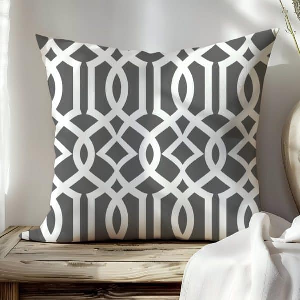 Gray Square Pillow With A White Geometric Lattice Pattern.