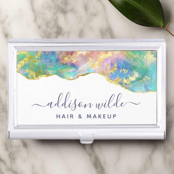 A Business Card For Addison Wilde Hair &Amp; Makeup. The Card Features A Pastel And Gold Abstract Design.