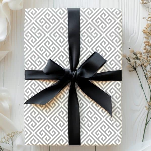 Gift Box With Gray Greek Key Pattern Wrapping Paper And Black Ribbon.