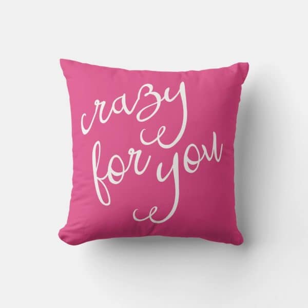 Pink Pillow With The Text Crazy For You In White Script Lettering.