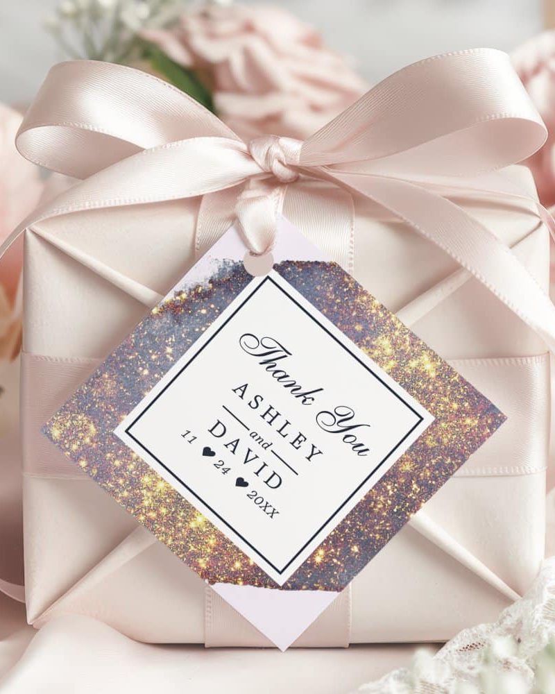 Wedding thank you gift tag with gold and purple galaxy design, names Ashley and David, and wedding date.