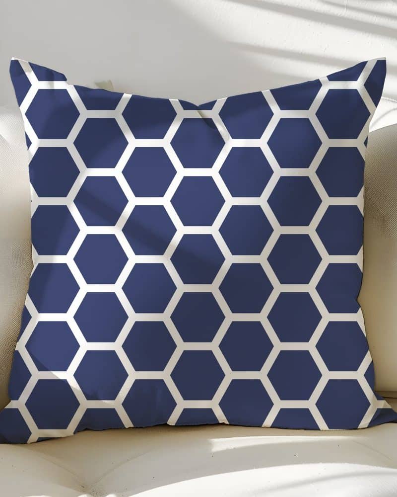 Navy blue throw pillow with a white honeycomb pattern.