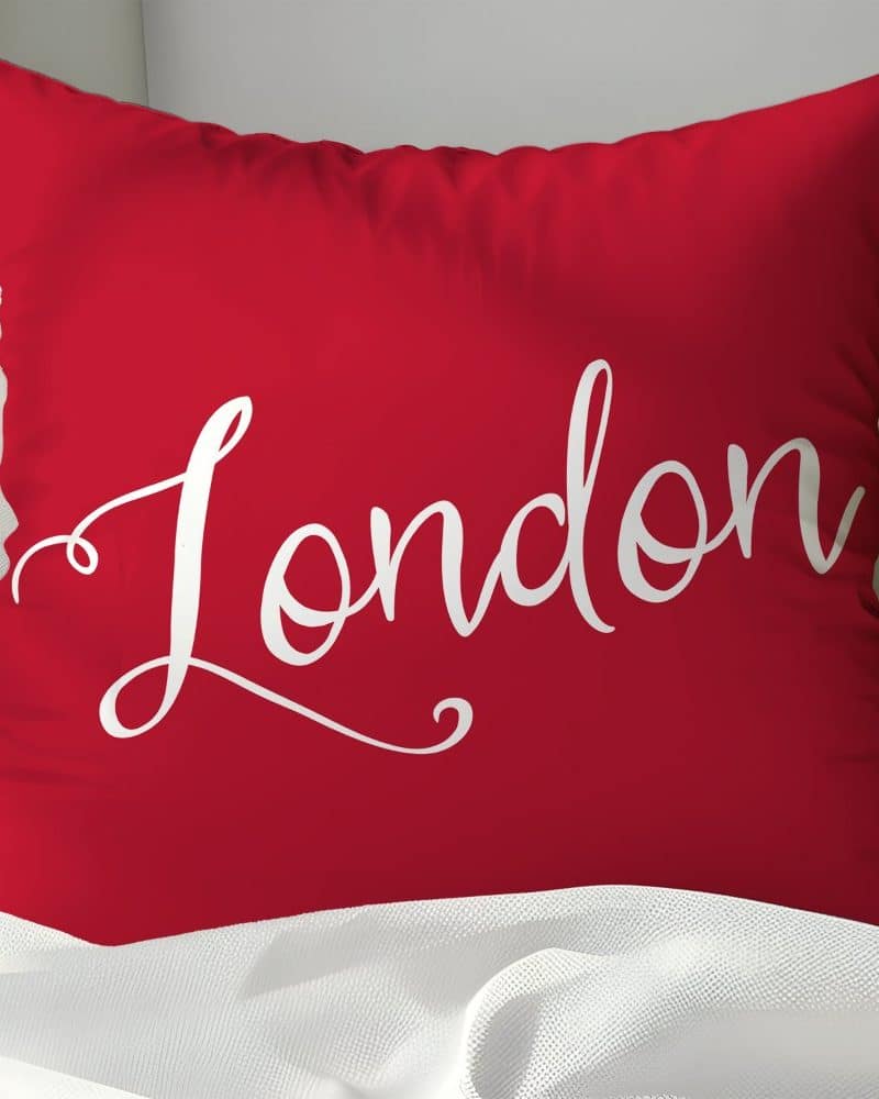 Red pillow with the word London in white script.