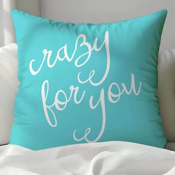 Teal Pillow With The Words Crazy For You In White Script.