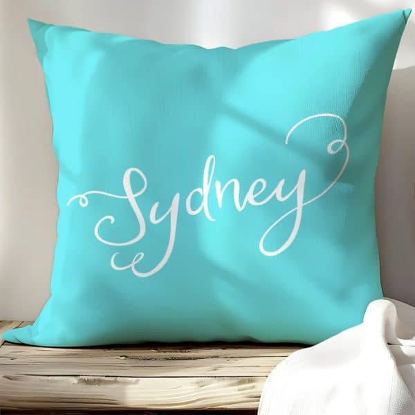 Teal Pillow With The Name Sydney In White Script.